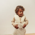 Boy holding Binibamba sheepskin hot water bottle lil' hottie