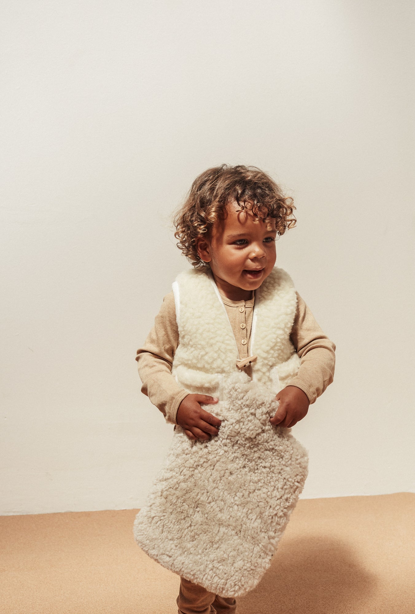 Boy holding Binibamba sheepskin hot water bottle lil' hottie