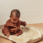 Peanut sheepskin snuggler pram liner by Binibamba in peanut colour in moses basket for baby