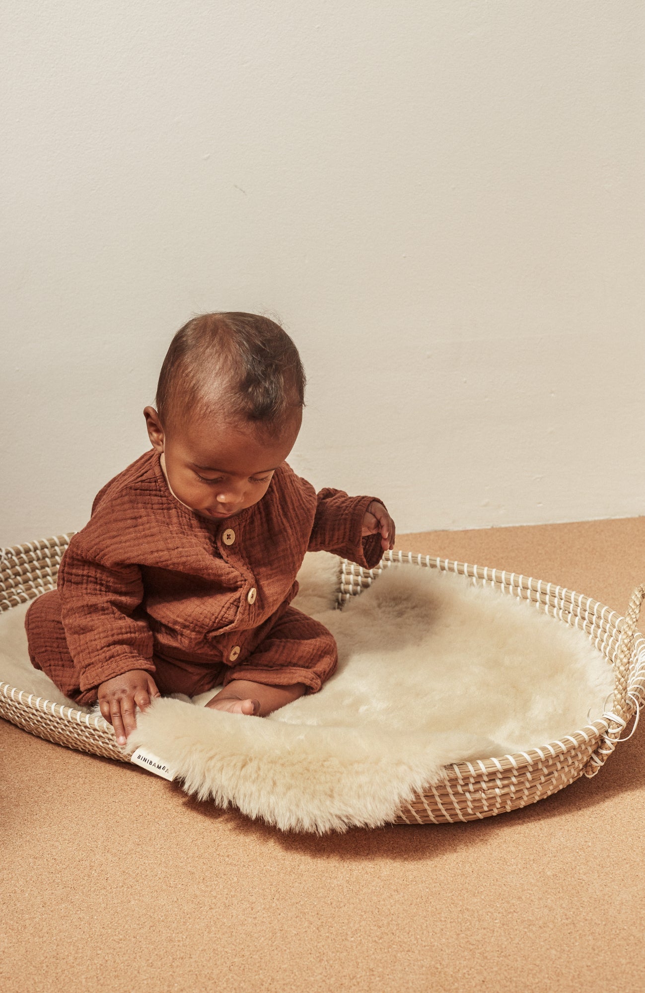 Peanut sheepskin snuggler pram liner by Binibamba in peanut colour in moses basket for baby