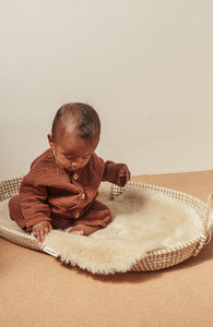 Peanut sheepskin snuggler pram liner by Binibamba in peanut colour in moses basket for baby